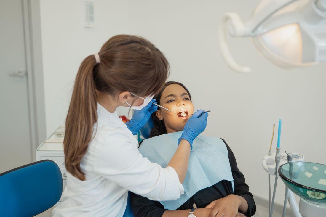 Dentist examining a patient at the clinic