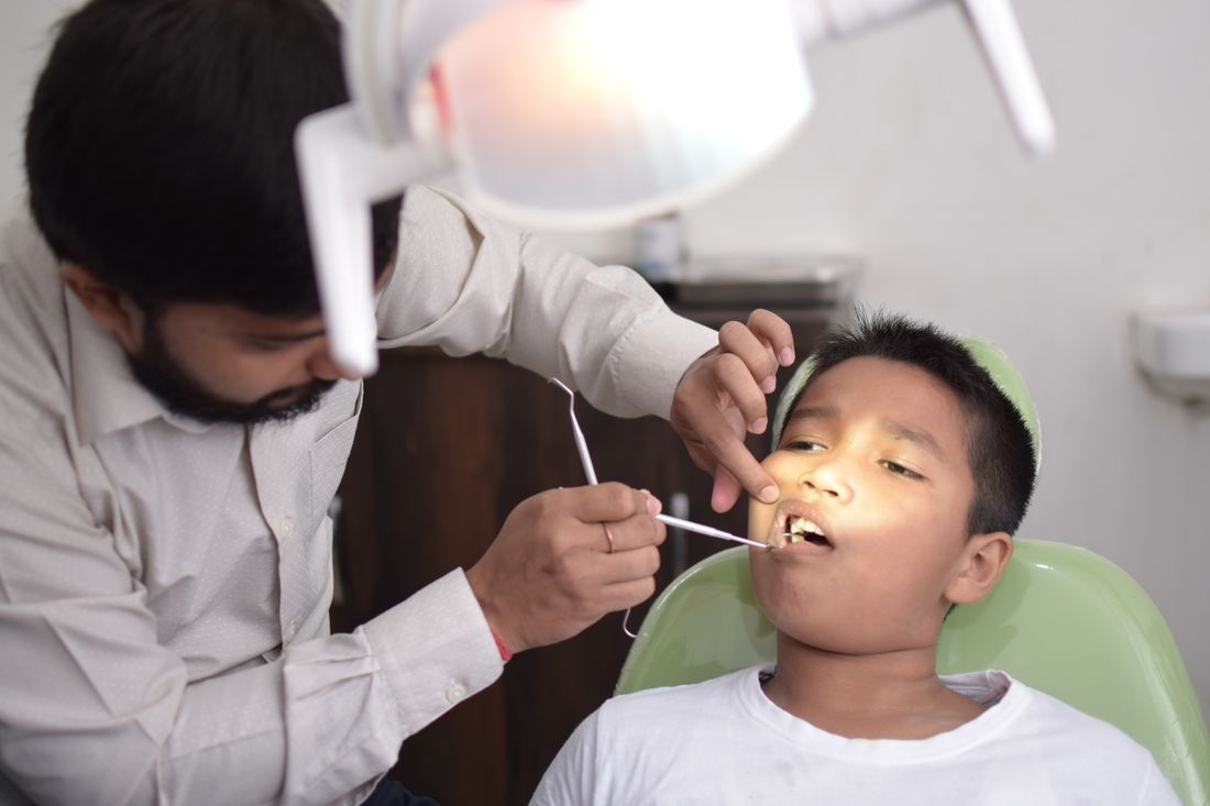 Dentist gently examining a child's teeth